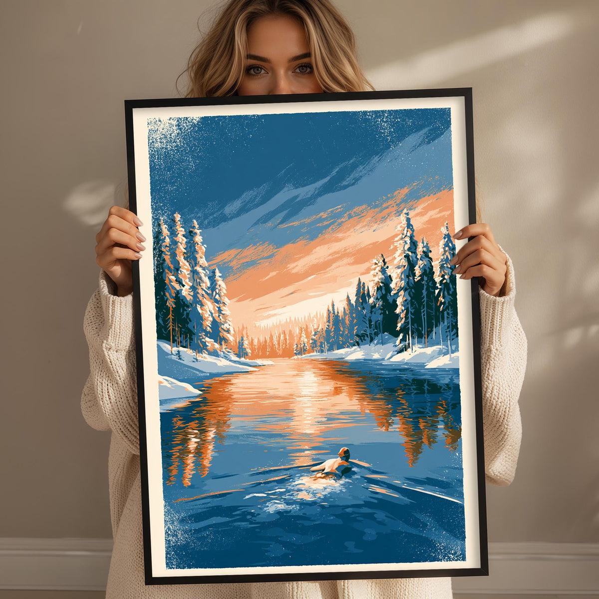 A woman holds up a framed painting depicting a serene winter landscape with a lake, snow-covered trees, and a person skiing on the water.