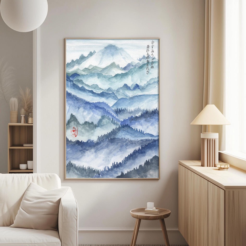 a large, framed painting of a mountainous landscape with a watercolor painting style. The painting is hung on a wall in a living room setting, with a white couch and a wooden side table nearby.