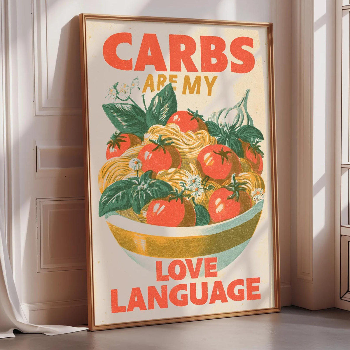 A framed poster with the text "CARBS ARE MY LOVE LANGUAGE" and an illustration of a bowl of food with tomatoes and other vegetables.