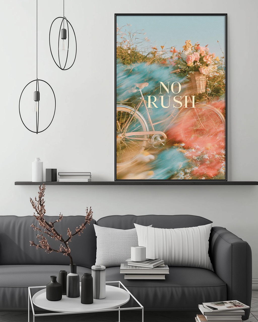 a modern living room with a gray sofa, a coffee table, and a large framed poster with a bicycle and flowers on the wall.
