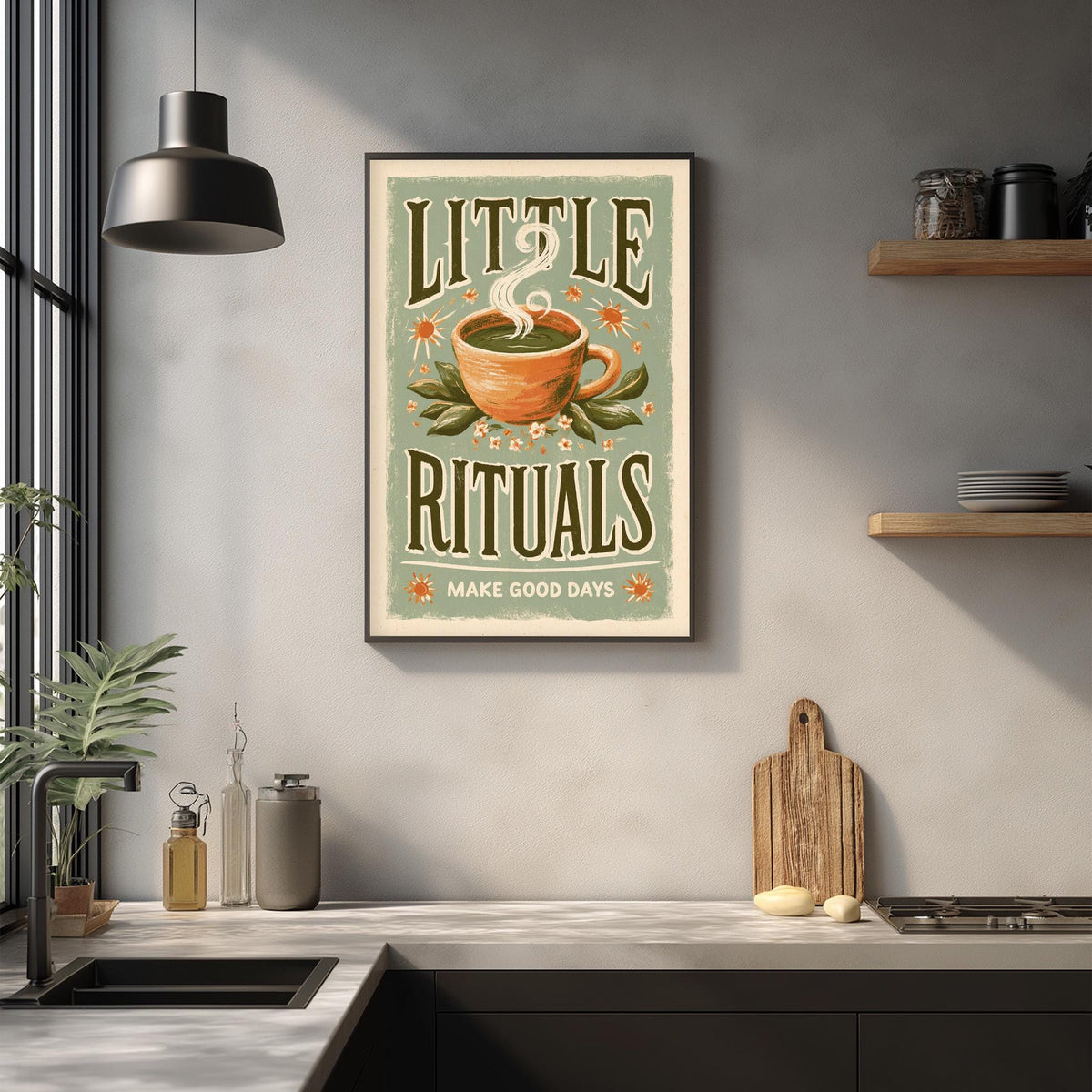 a kitchen counter with various items such as a cutting board, a soap dish, and a potted plant. Above the counter, there is a framed poster with the text "LITTLE RITUALS MAKE GOOD DAYS" and an illustration of a cup with a steamy beverage.