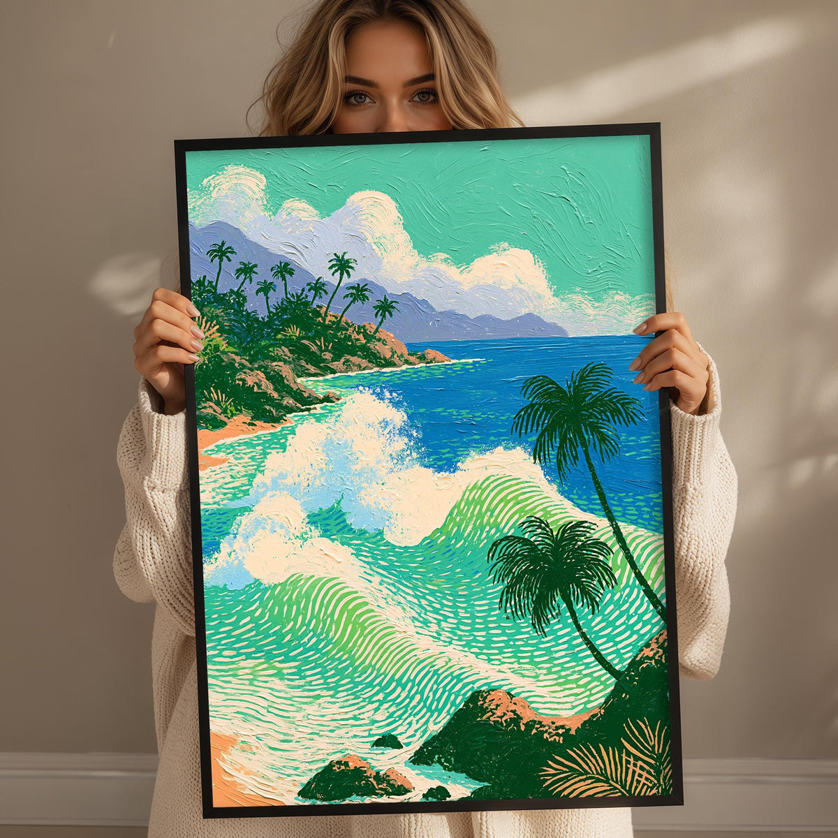 A woman holds up a framed painting depicting a tropical beach scene with palm trees, crashing waves, and a clear blue sky.