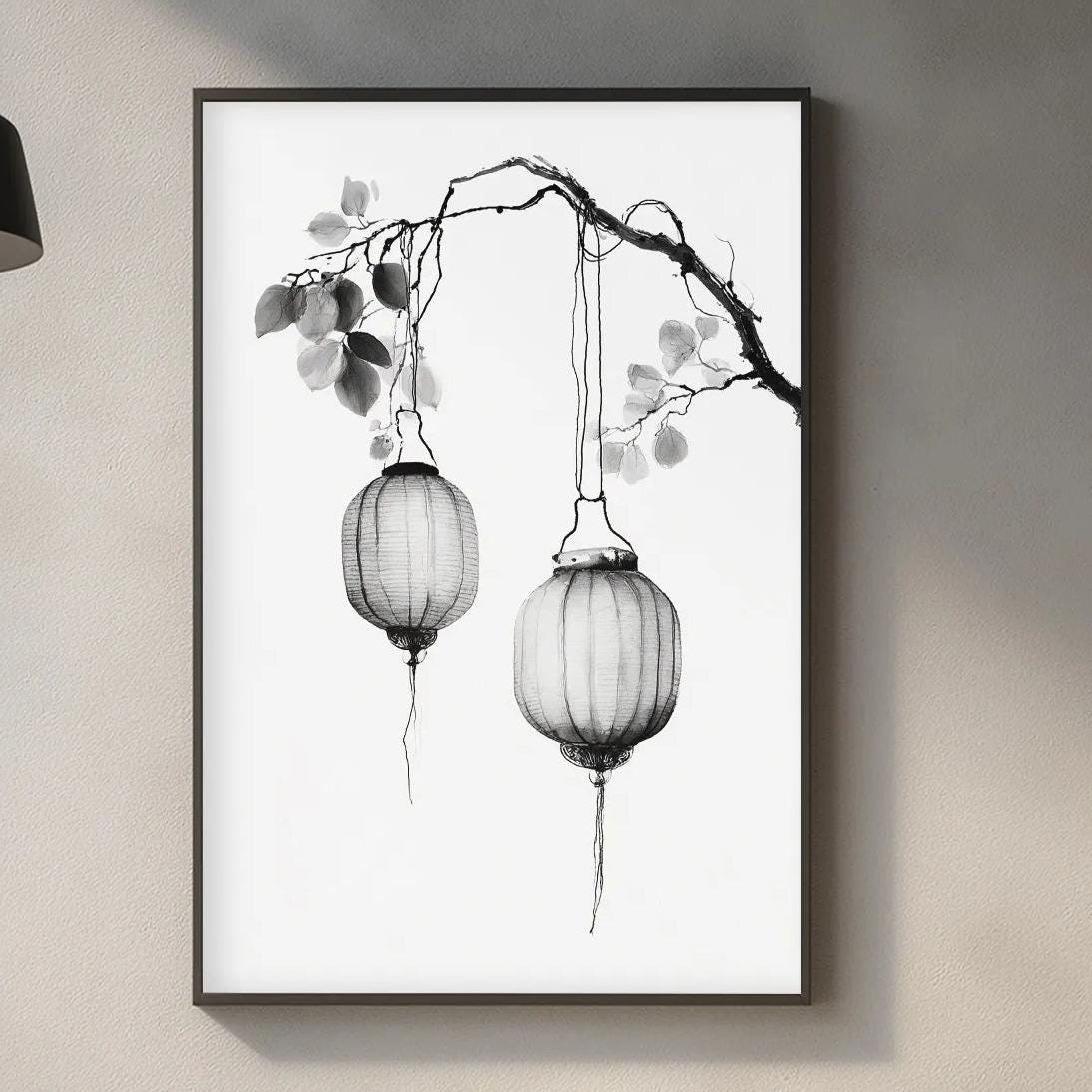a minimalist kitchen interior with a framed black and white illustration of a branch with hanging lanterns as the focal point. The kitchen counter has various items such as a cutting board, a bottle, and a vase, creating a cozy and functional space.