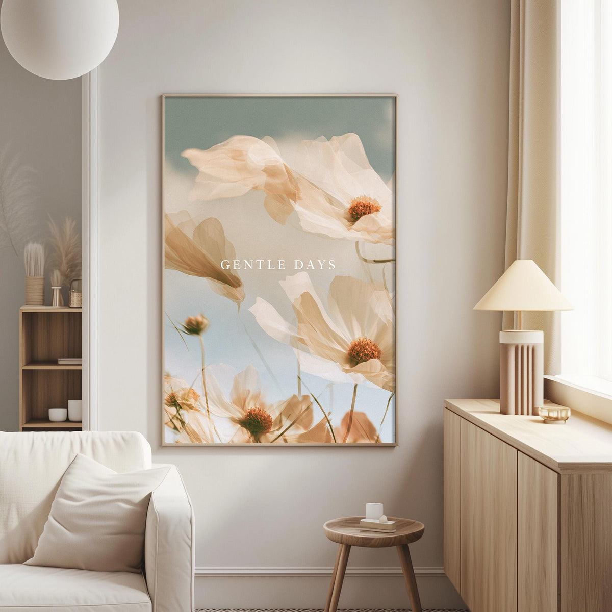 a living room with a large framed poster of flowers hanging on the wall, a white sofa, a wooden side table, and a lamp on a wooden cabinet.
