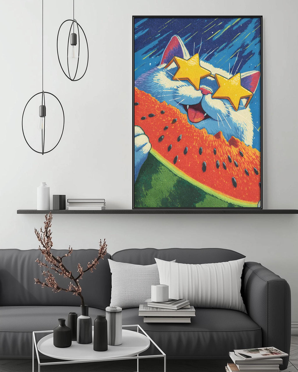 a large, colorful painting of a cat wearing sunglasses and holding a watermelon slice, hanging on a wall above a gray couch with a coffee table in front of it.