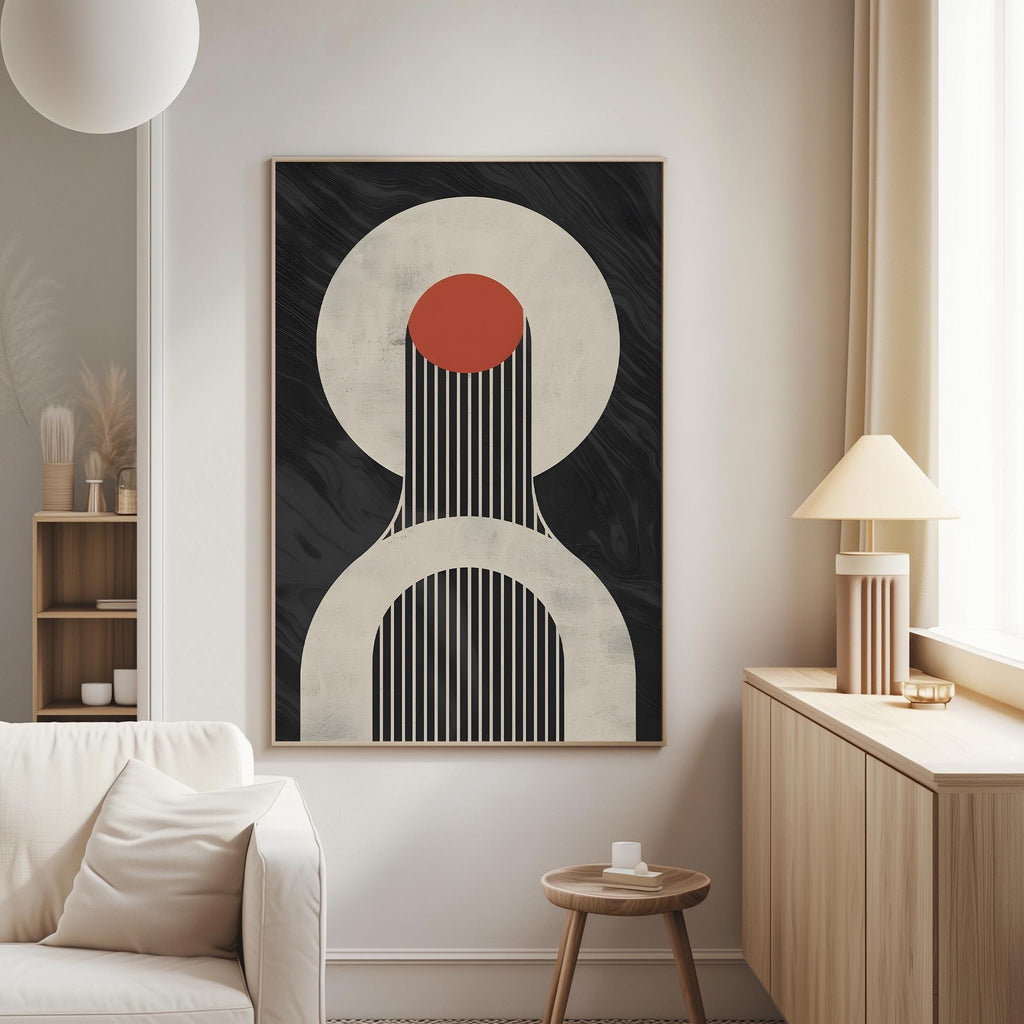 a modern living room with a minimalist design. The focal point is a large abstract painting with bold black and white colors, including a red circle and a black and white striped pattern. The painting is hung on the wall above a white couch, which is positioned against a wooden cabinet. A small side table is located next to the couch, and a lamp is placed on the side table. The overall design of the room is clean and uncluttered, with a focus on simplicity and functionality.