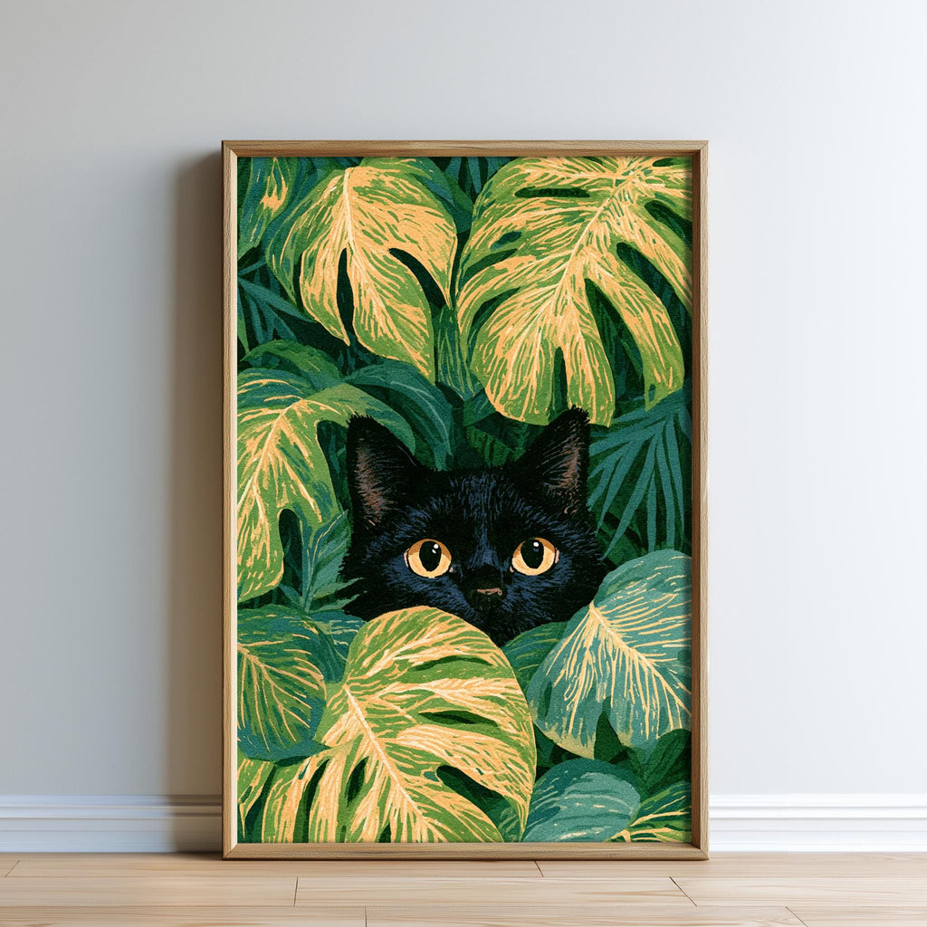 A framed print depicting a black cat peeking out from a lush, tropical plant with large, vibrant leaves.