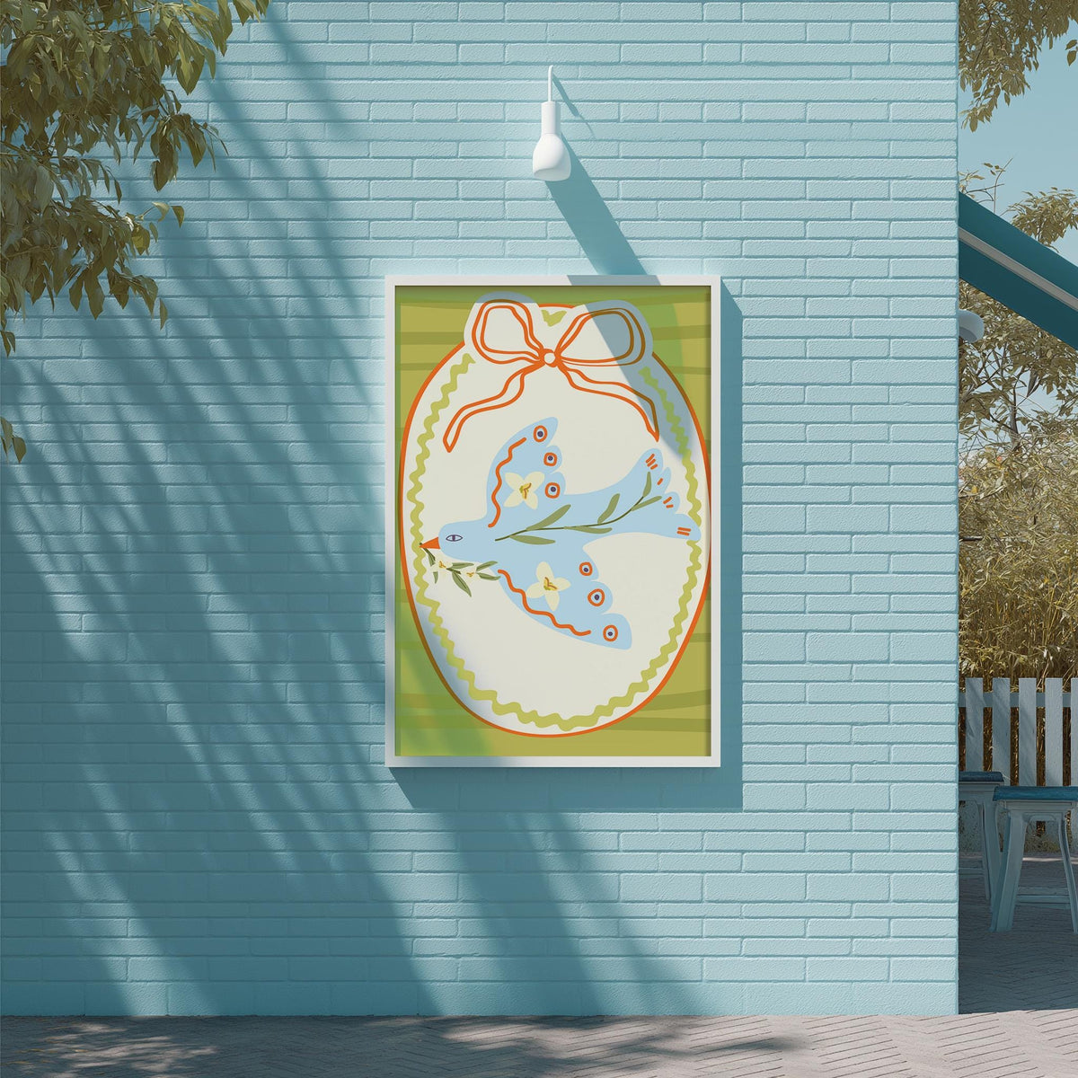 a blue brick wall with a framed illustration of a bird, possibly a dove, hanging on it.