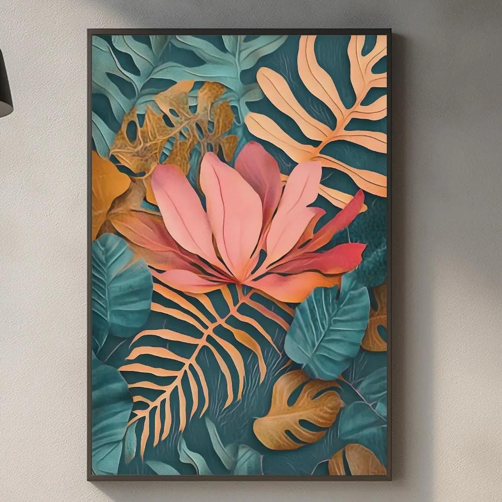 a kitchen counter with a framed print of tropical plants hanging on the wall above it. The print has a vibrant mix of pink, green, and orange colors, creating a lively and tropical atmosphere. The kitchen counter also has various items such as a cutting board, a bottle, and a vase, adding to the overall aesthetic of the space.