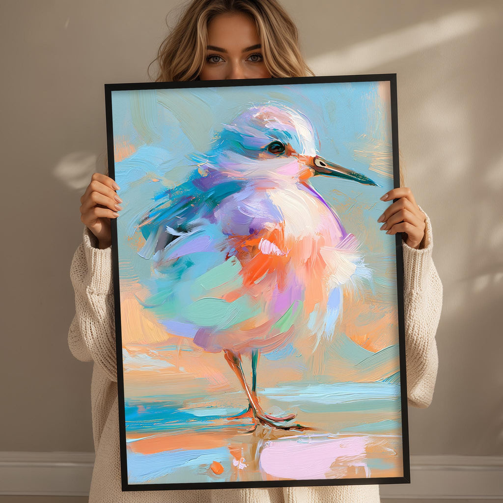 A woman holds up a framed painting of a colorful bird, showcasing its vibrant feathers and intricate details.