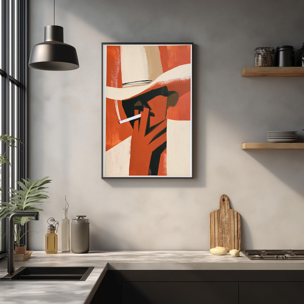 a modern kitchen with a framed abstract painting hanging on the wall above a countertop. The painting depicts a person wearing a hat and smoking a cigarette. The kitchen countertop has various items, including a cutting board, a bottle, and a vase. The overall scene has a minimalist and contemporary design.