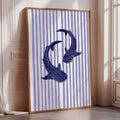 a framed artwork depicting two blue sharks swimming in a striped pattern.