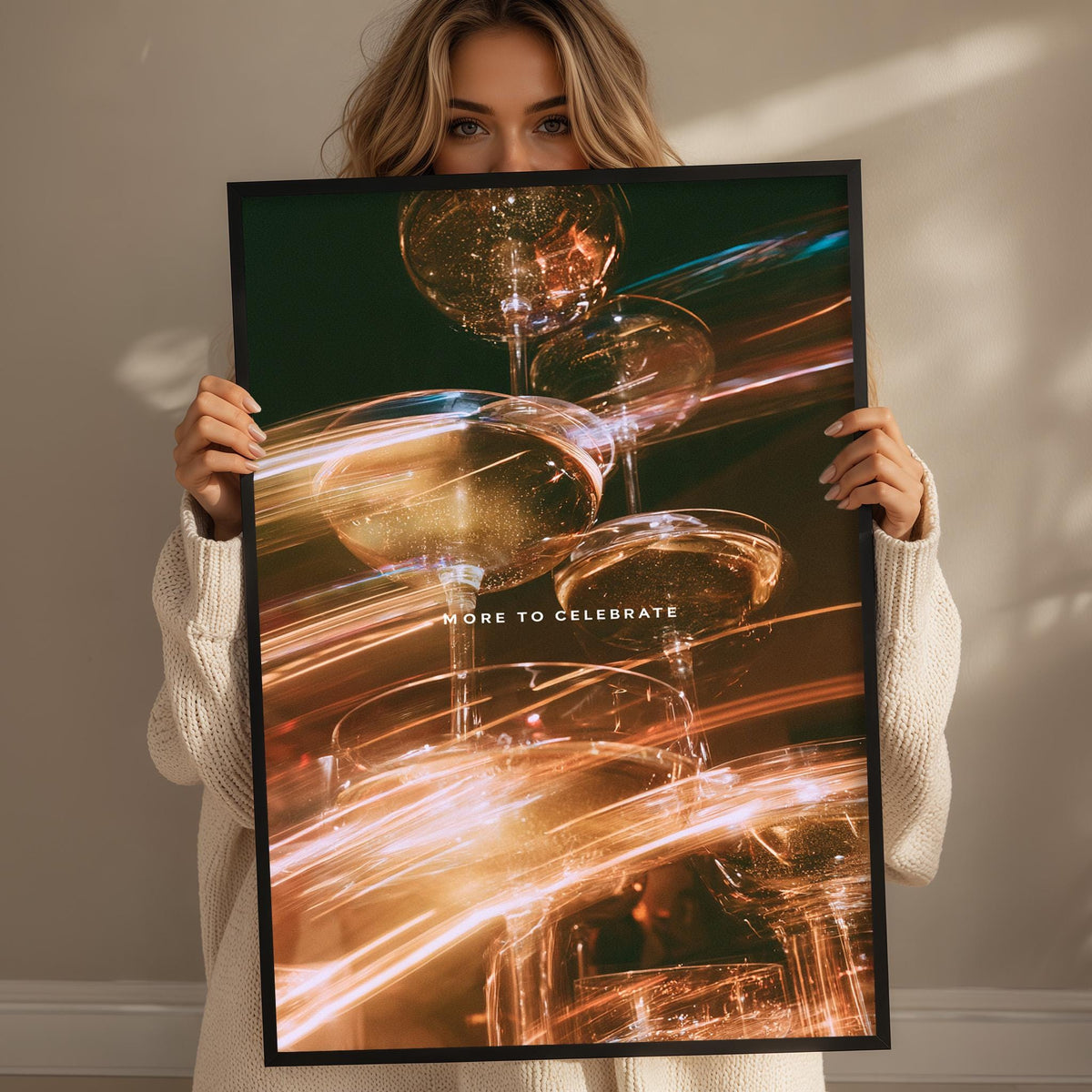 A woman holding a framed poster with a vibrant, abstract design featuring various shapes and colors, including gold, orange, and blue.