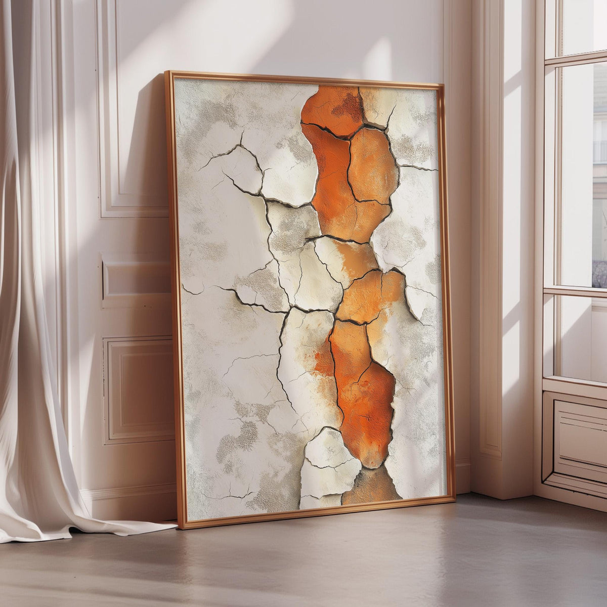 a large, framed painting with a striking abstract design of orange and white cracks and patterns.
