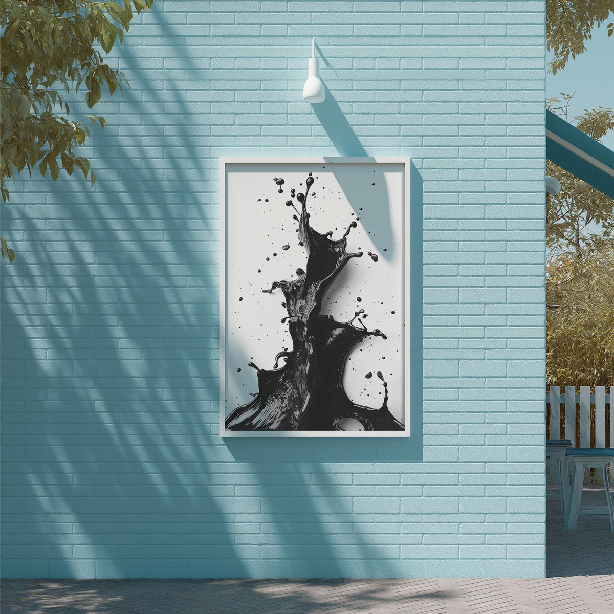 a blue brick wall with a framed black and white abstract painting hanging on it.