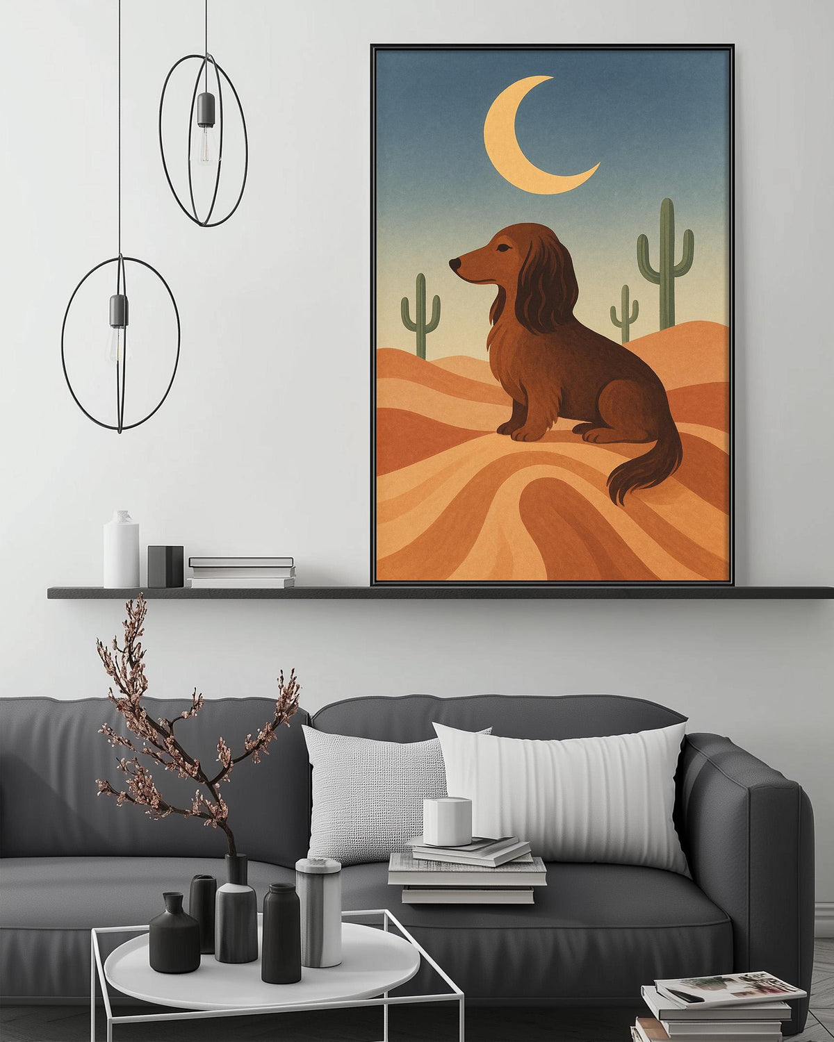 a cozy living room with a gray sofa, a coffee table, and a framed illustration of a dog sitting on a desert landscape with a cactus and a crescent moon in the background.