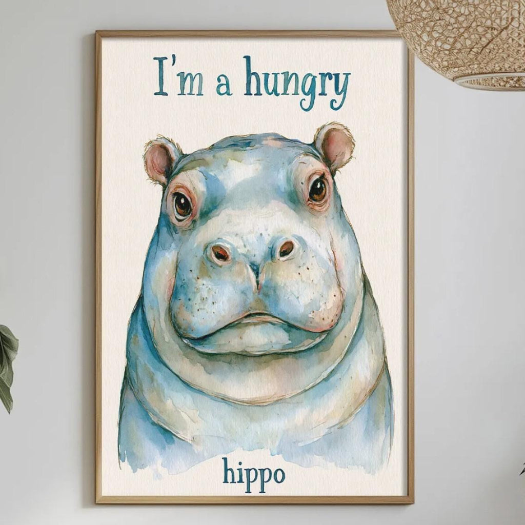 a framed poster of a hippopotamus with the text "I'm a hungry hippo" on it, hanging on a wall above a dining table with various items on it.