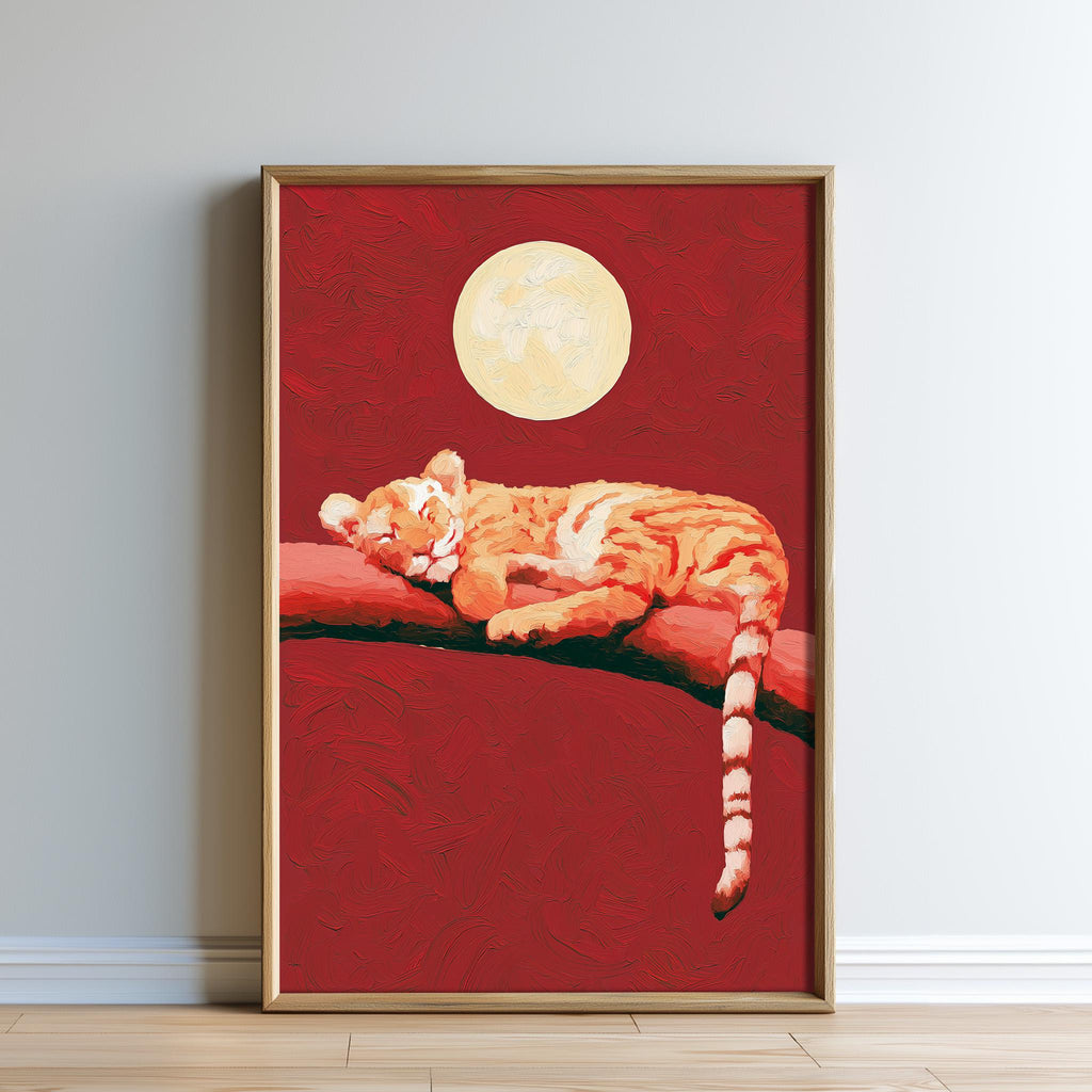 A framed painting depicting a sleeping tiger on a branch against a red background with a full moon in the sky.