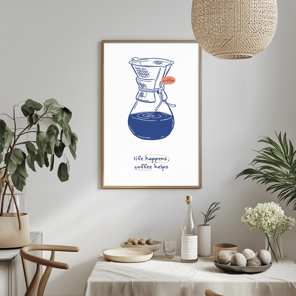 a framed illustration of a coffee maker on a wall, with the text "life happens, coffee helps" below it. The room has a dining table with a vase of flowers, a bottle, and a bowl of balls, creating a cozy and inviting atmosphere.