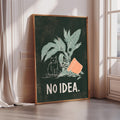 a framed poster with a cat sitting on a plant and the text "NO IDEA."