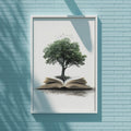 a framed artwork depicting a tree growing out of an open book, set against a blue brick wall.