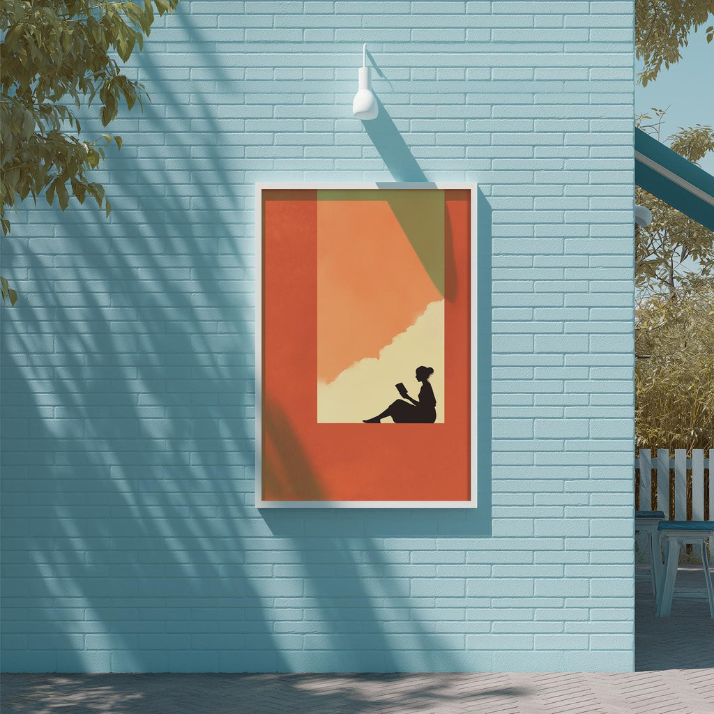 a blue brick wall with a framed picture of a person sitting and reading, which is hanging on the wall.
