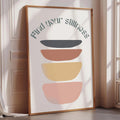 a framed poster with a minimalist design, featuring a series of abstract shapes in various colors.
