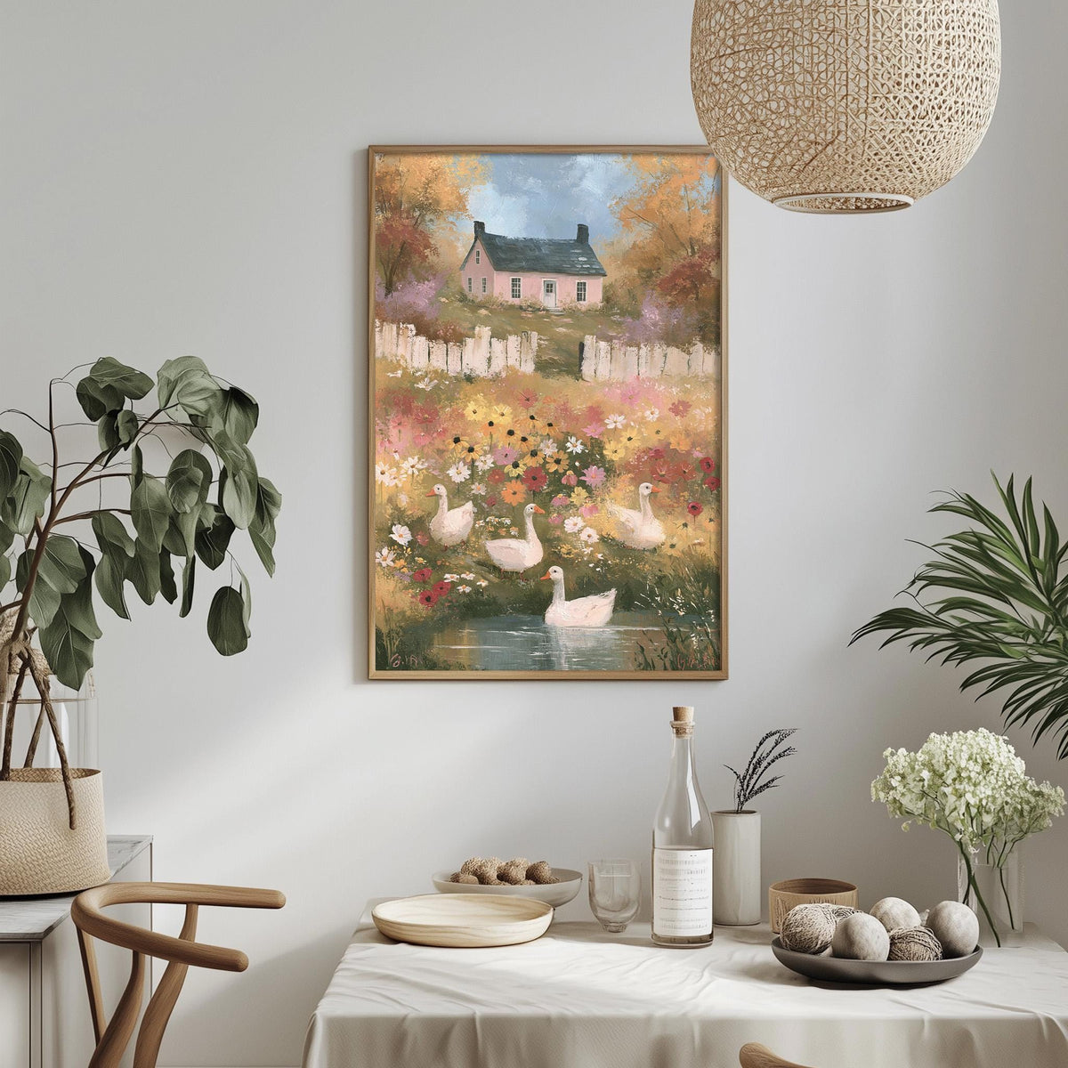 a cozy dining area with a table set for a meal, surrounded by potted plants and a hanging light fixture. A framed painting of a pastoral scene with ducks and flowers is displayed on the wall above the table.