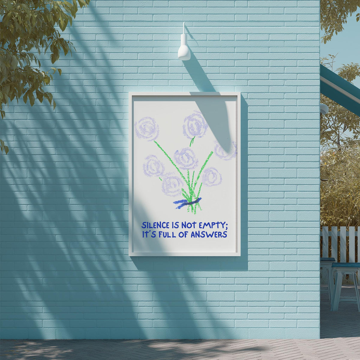 a blue brick wall with a framed poster hanging on it. The poster has a drawing of purple flowers and the text "Silence is not empty; it's full of answers".