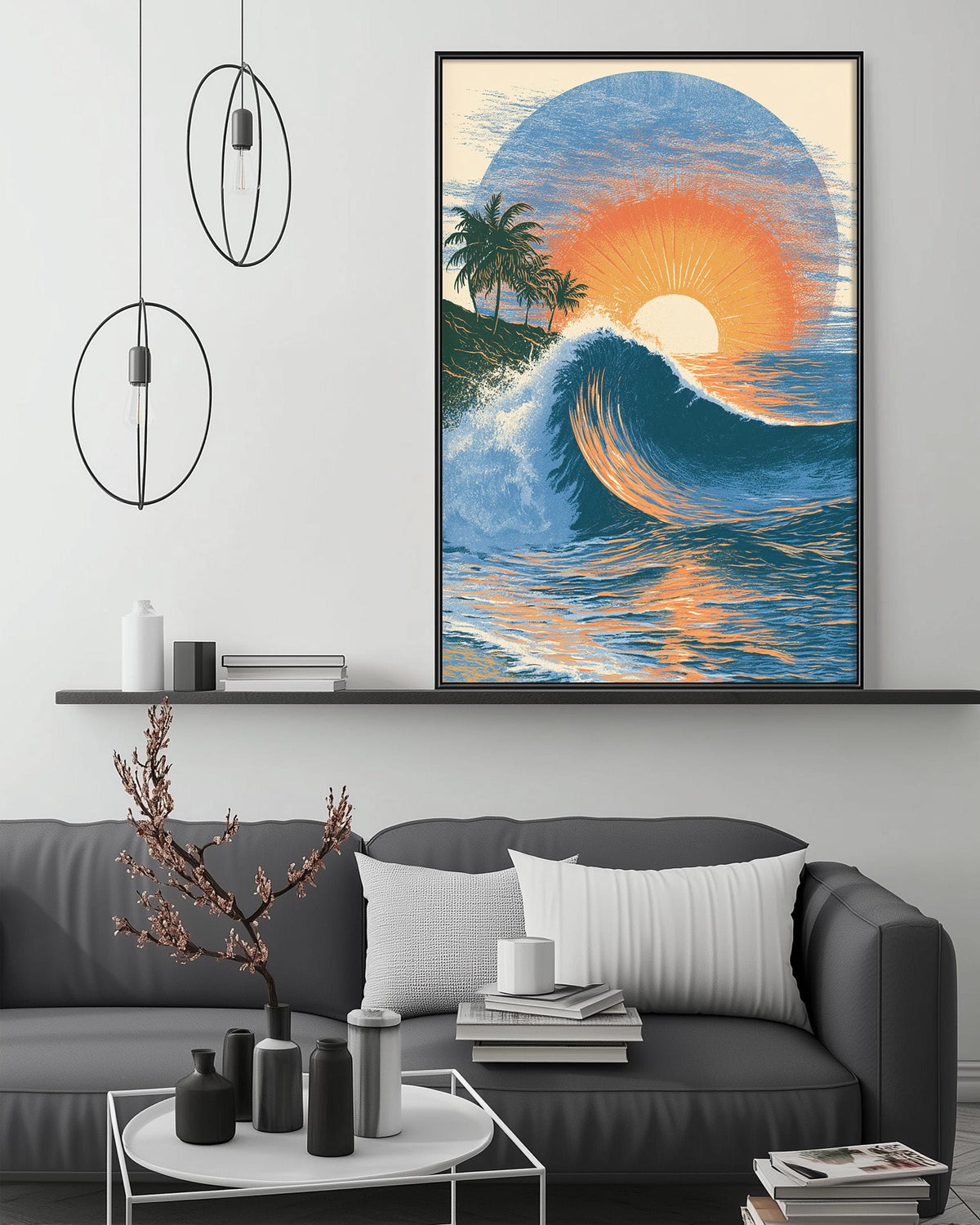 a large framed painting of a sunset over the ocean, hanging on a wall above a gray couch with a coffee table in front of it.