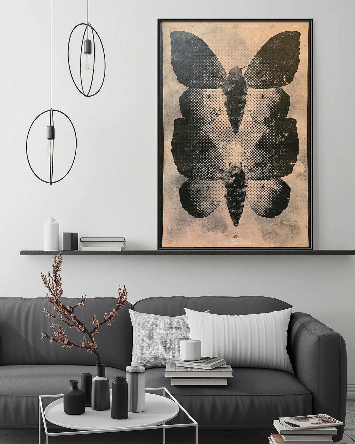 a modern living room with a gray sofa, a coffee table, and a large framed print of black and white butterflies hanging on the wall above the sofa.