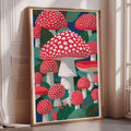 a large framed artwork depicting a vibrant and colorful scene of red and white mushrooms against a lush green background.