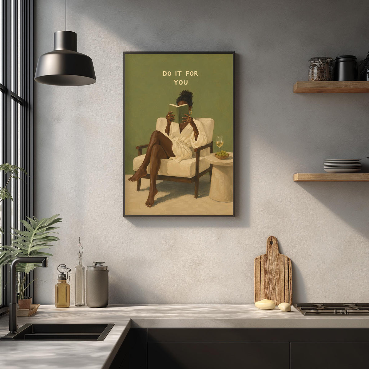 a framed painting of a woman sitting in a chair, reading a book, with the text "Do it for you" above her. The painting is displayed on a wall above a kitchen counter with various kitchen items, such as a cutting board, a bottle, and a bowl.