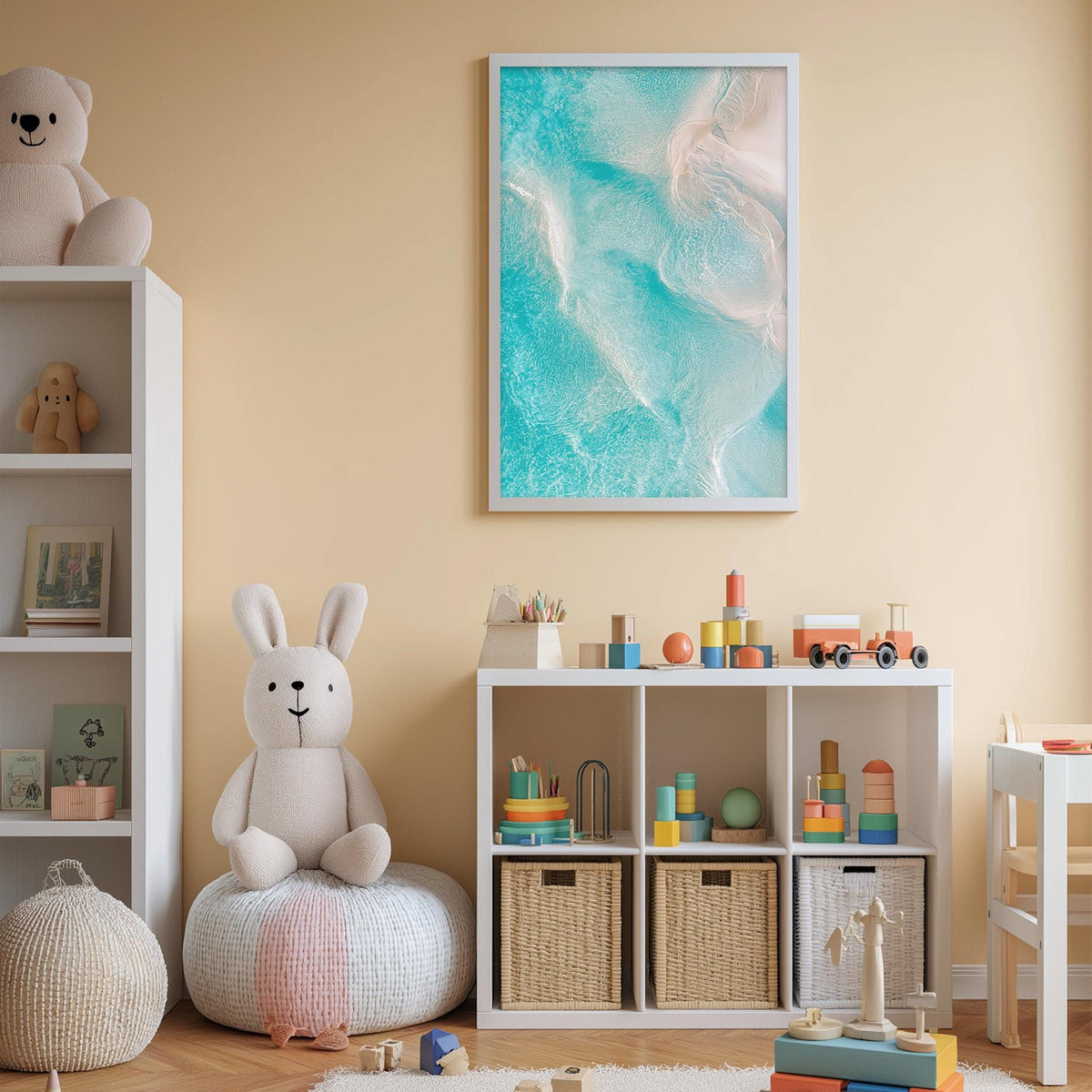 A cozy and colorful children's bedroom with a large stuffed bunny, a bookshelf, and a toy chest filled with toys. The walls are painted a light peach color, and a framed picture of a beach scene hangs above the bookshelf.