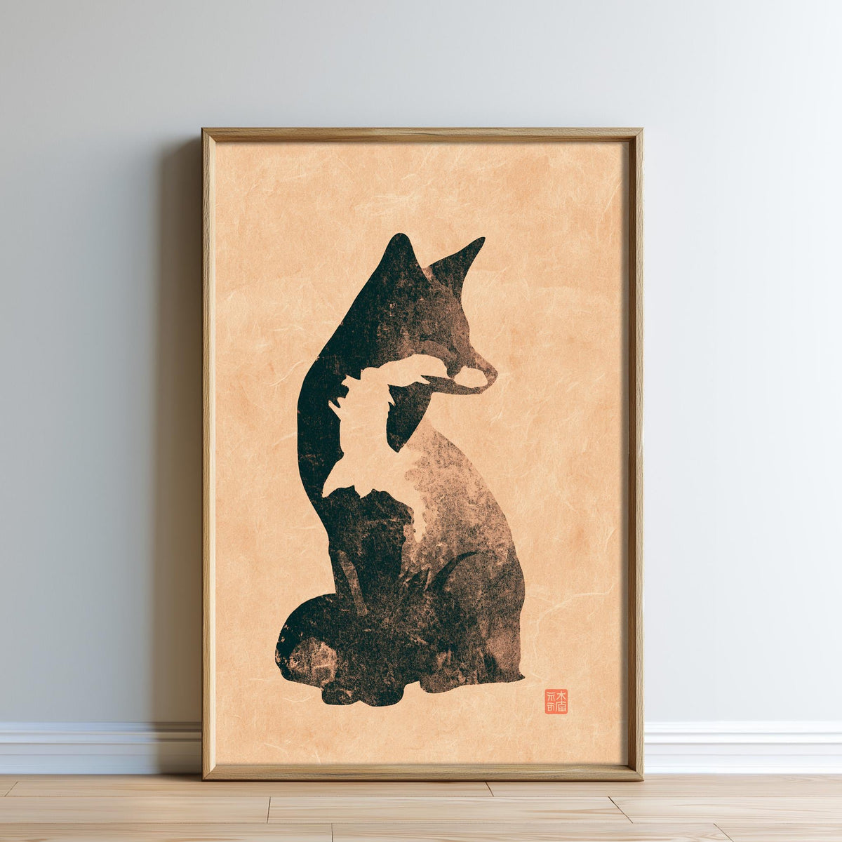 a framed artwork depicting a black and white cat sitting on a wooden floor.