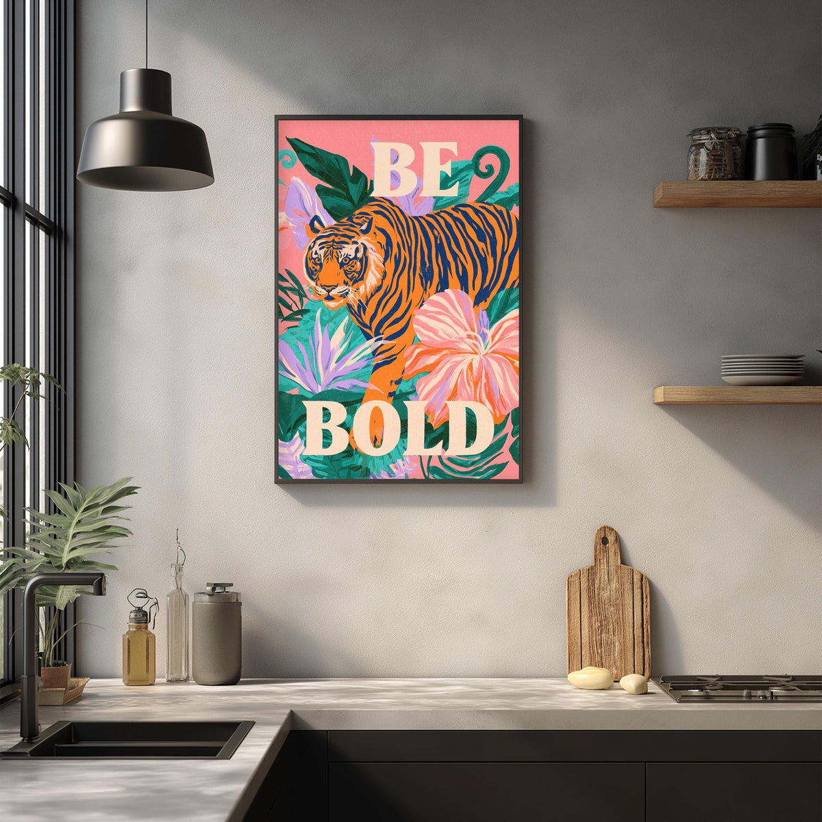 a kitchen counter with a framed poster of a tiger surrounded by tropical plants and flowers, along with a wooden cutting board and other kitchen items.