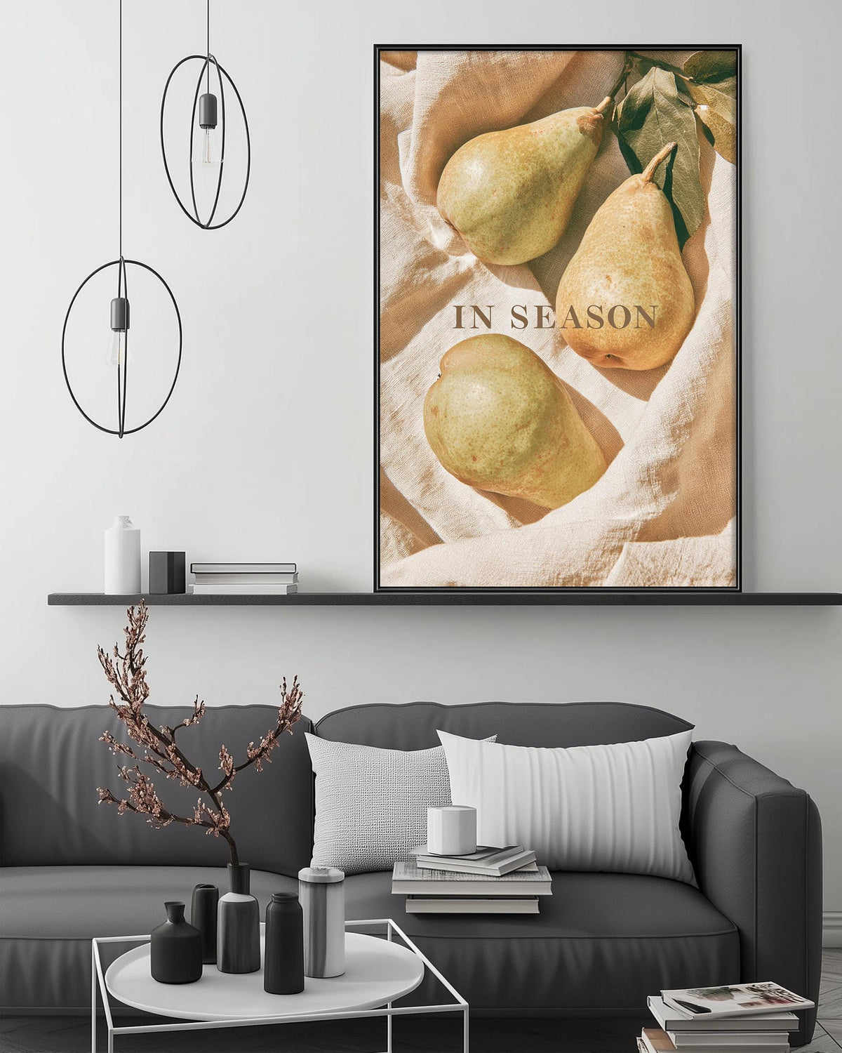 a cozy living room with a gray sofa, a coffee table, and a framed picture of pears on the wall.