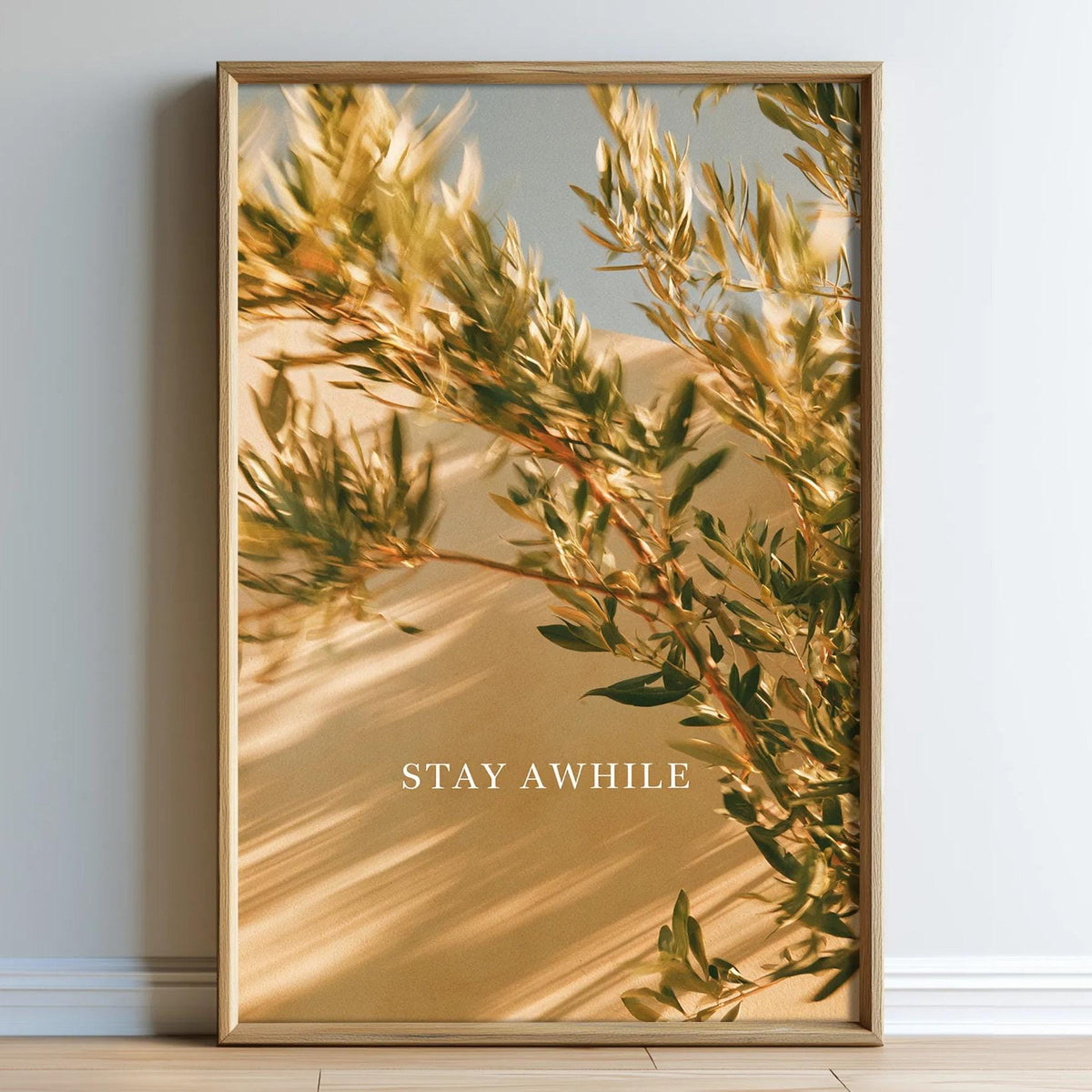 The image is a framed print of a tree branch with green leaves, set against a light background.