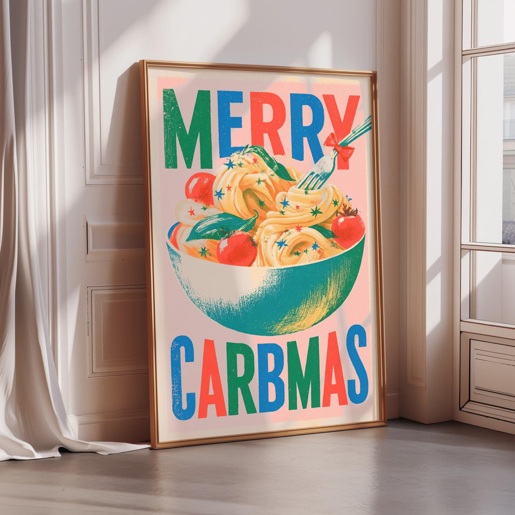 A framed poster with a colorful illustration of a bowl of food, along with the text "MERRY CARBMAS" displayed prominently.