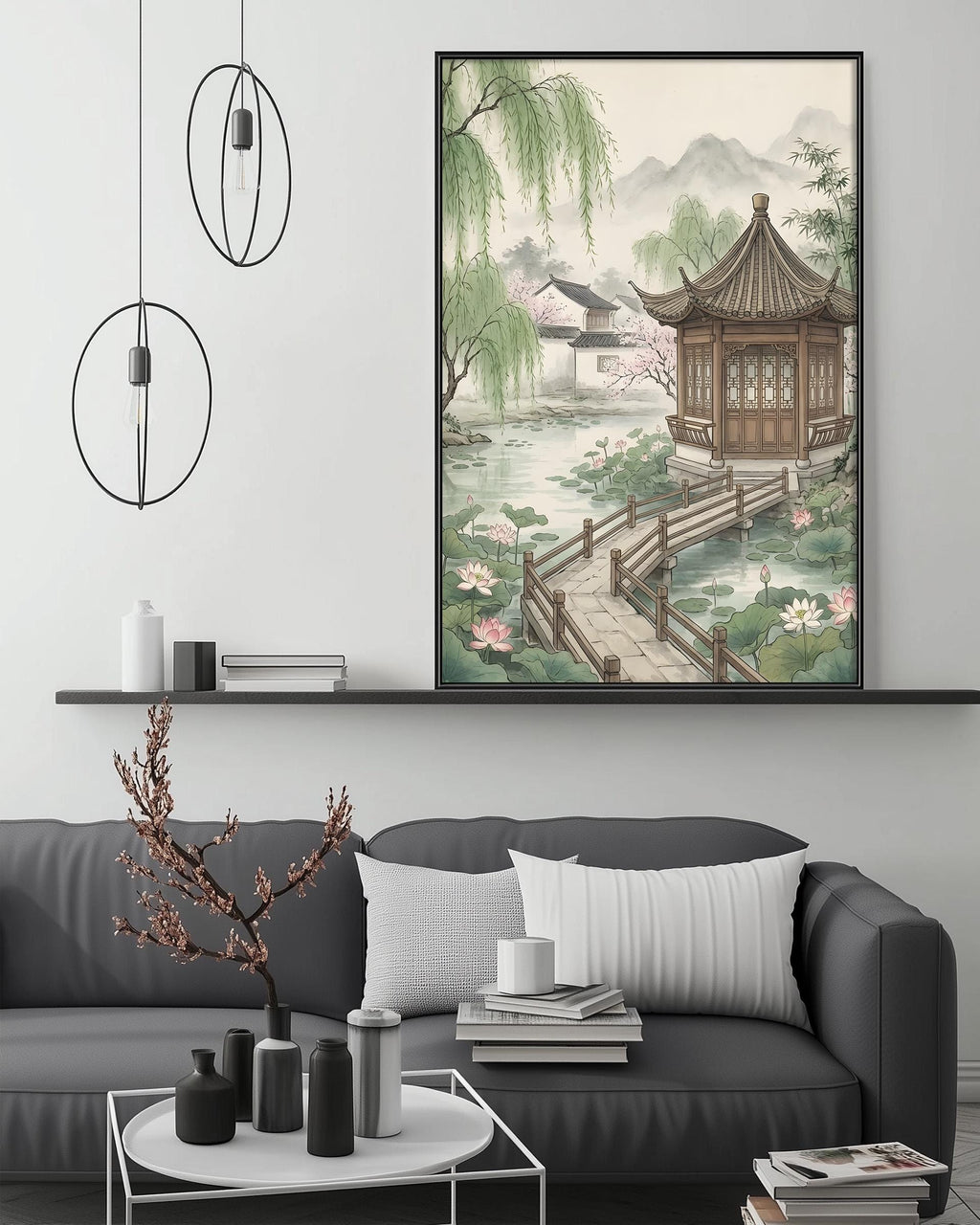 a living room with a gray sofa, a coffee table, and a large framed painting of a traditional Chinese pavilion with a garden scene above it.