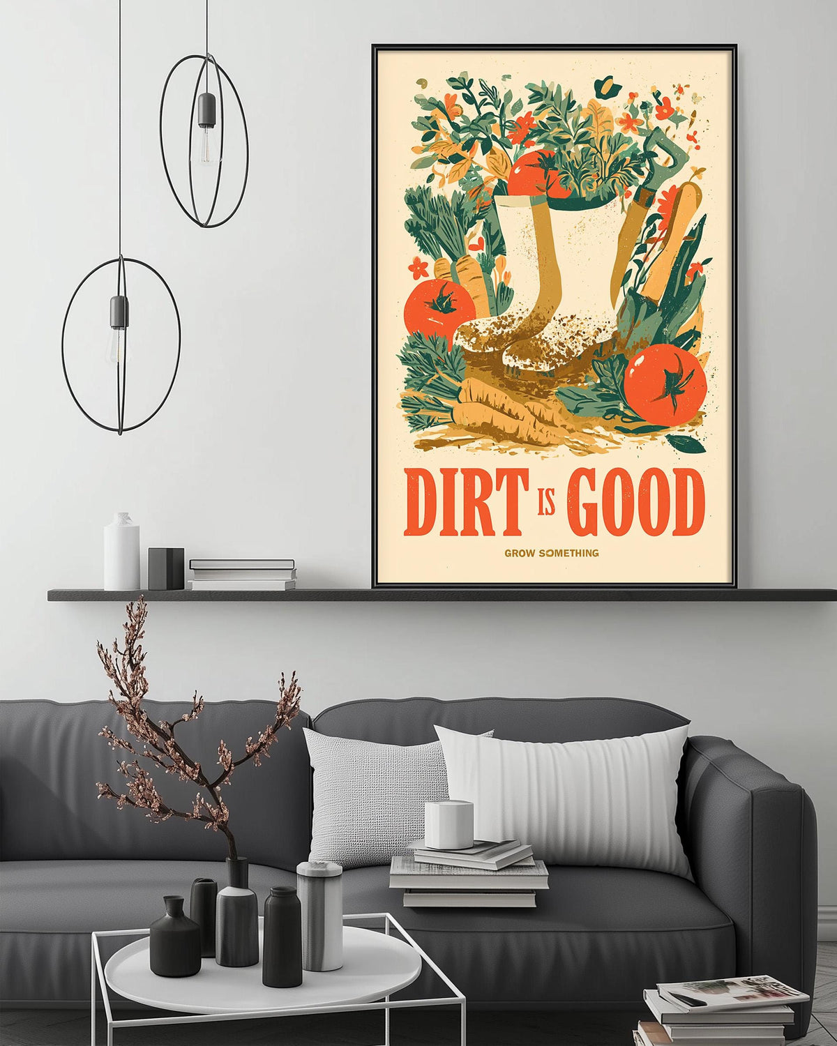 a living room with a gray couch, a coffee table, and a framed poster on the wall. The poster has a colorful illustration of a garden scene with various plants and flowers, along with the text "Dirt is good. Grow something."
