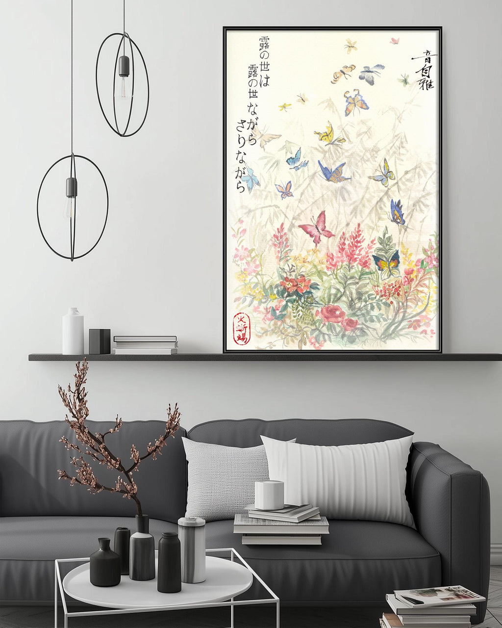 a living room with a gray sofa, a coffee table, and a large framed print of a floral design with butterflies on the wall above the sofa.