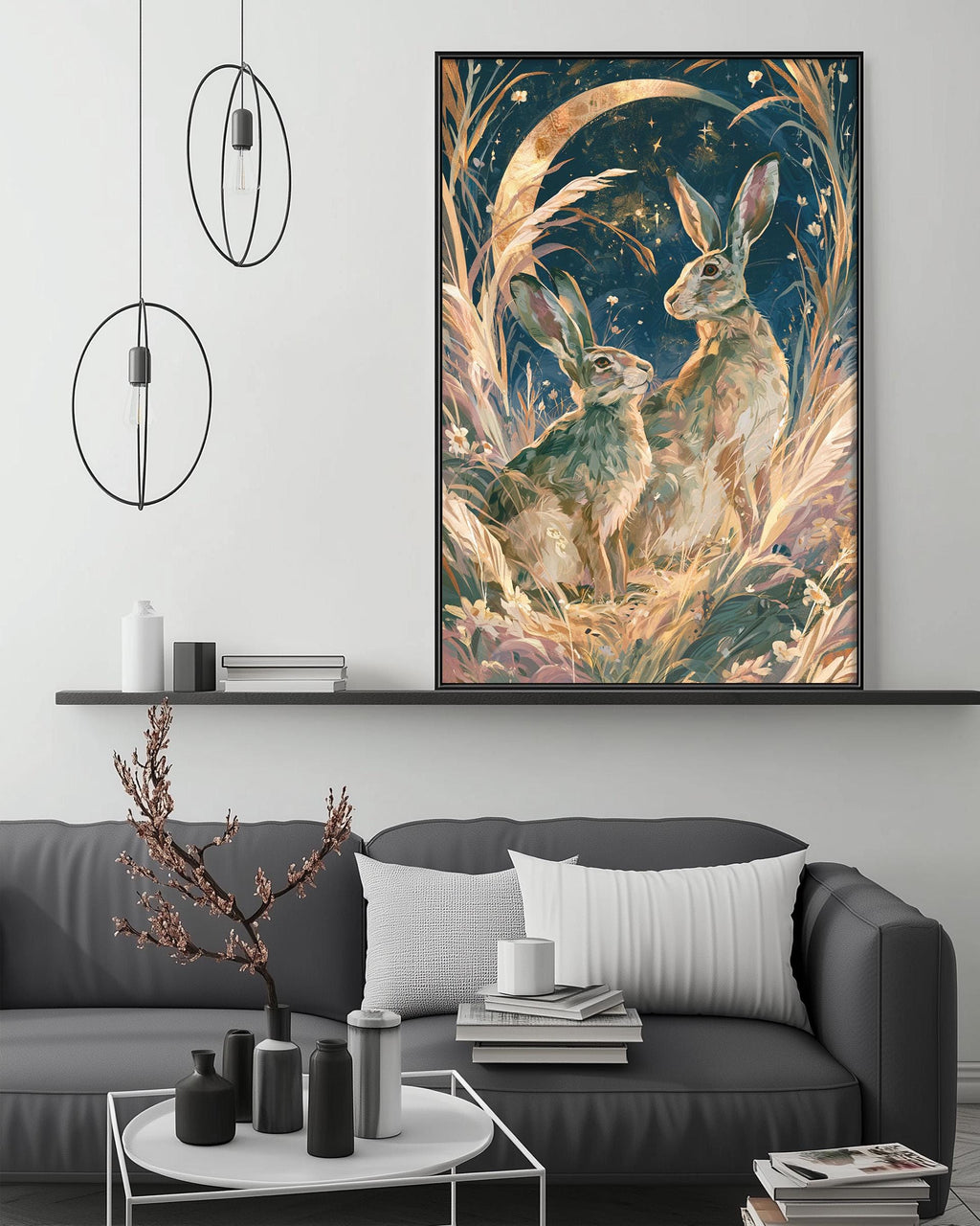 a large, colorful painting of two rabbits in a field, hanging on a wall above a gray couch with a coffee table in front of it.