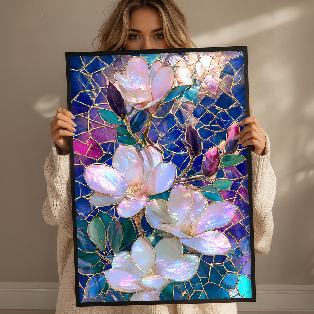 A woman holds up a framed stained glass artwork featuring a vibrant floral design with pink and purple flowers against a blue background.