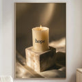 a cozy living room with a white sofa, a wooden side table, and a framed picture of a lit candle on a stone block.