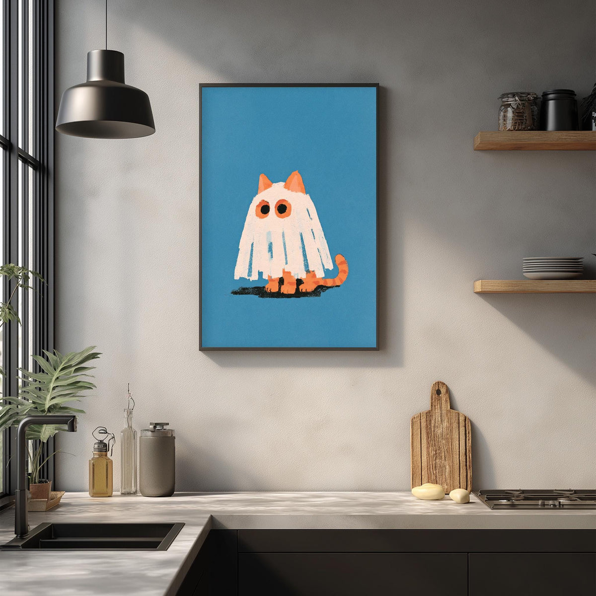 a kitchen counter with a framed illustration of a ghost cat on the wall above it.
