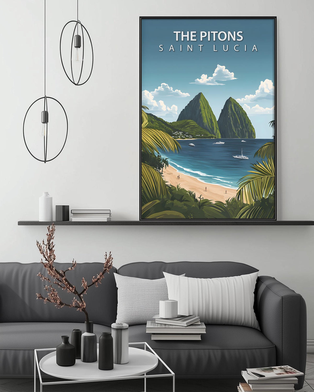 a large framed poster of a tropical island landscape, with mountains, palm trees, and a beach, hanging on a wall above a gray couch with a coffee table in front of it.