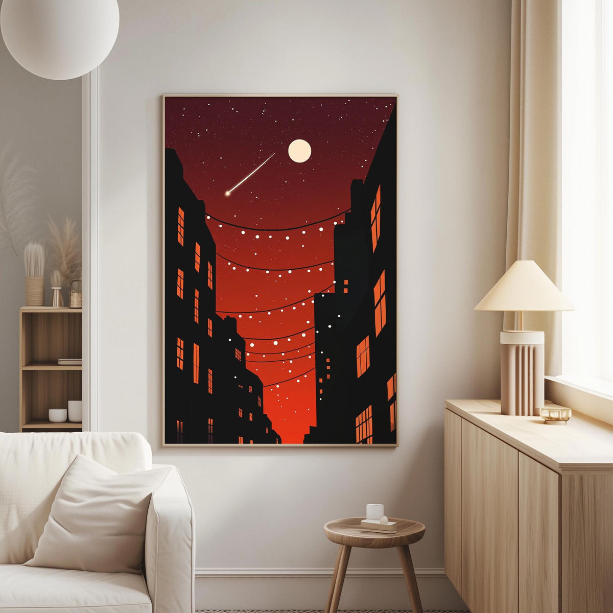 a cozy living room with a white sofa, a wooden side table, and a framed artwork of a cityscape at night with a full moon and string lights.