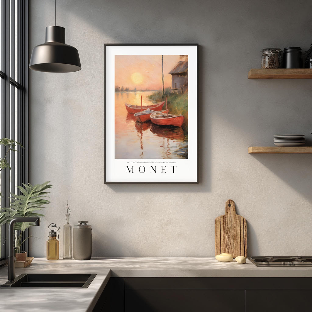 a framed painting of a sunset over a body of water, with two boats floating on the water. The painting is hanging on a wall above a kitchen counter, which has various kitchen items such as a cutting board, a bottle, and a vase.