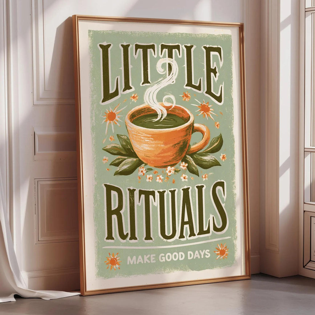 A framed poster with the text "LITTLE RITUALS MAKE GOOD DAYS" and an illustration of a cup of tea with steam rising from it.